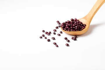 Group of red beans in a wooden spoon on white background

