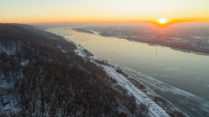 Beautiful sunset over a river with a city in the background