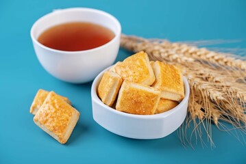 Healthy homemade crackers in a bowl on a blue background