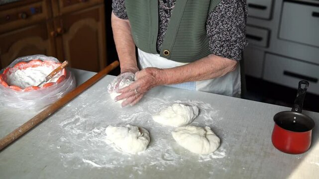 Senior woman making dough balls for baking