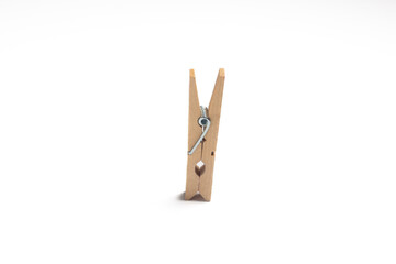 Wooden clothes peg isolated on white background
