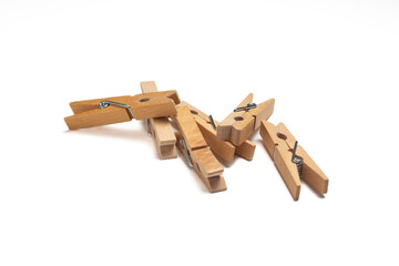 Group of wooden clothes pegs isolated on a white background