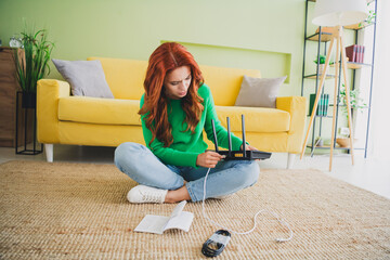 Full size photo of pretty young woman sit floot connect cable router weekend green interior...
