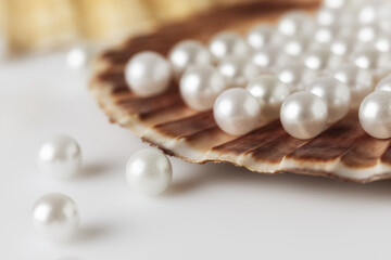 Beautiful white sea pearls on a white backdrop