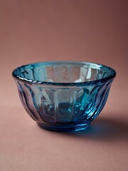 Blue glass bowl on pink background.