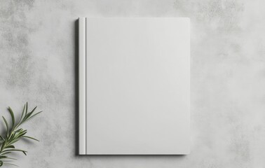 Blank notebook on a gray surface with flowers beside it for creativity and inspiration