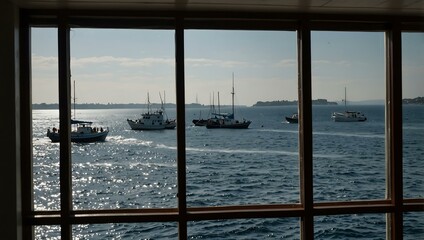 Boats at sea seen through a window.
