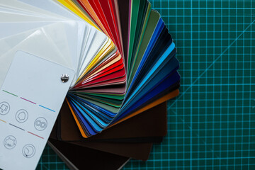 Set of color cards for car wrapping and protection. Film detailing auto. Workspace with green table and grid. Colors. Detailing