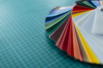 Set of color palette examples of protective film for car on green desktop. Detailing