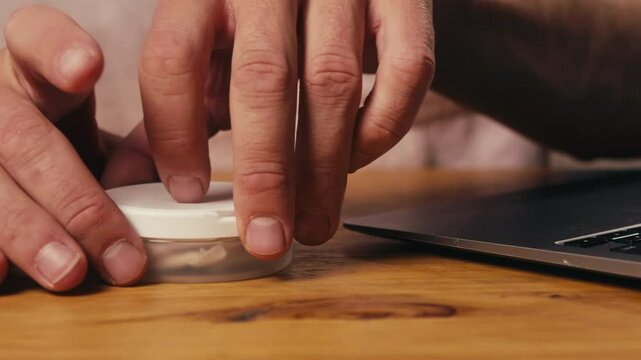 Snus nicotine tobacco close up, pack of tobacco for gum. unhealthy addiction. Man opening box with snus and taking one. 