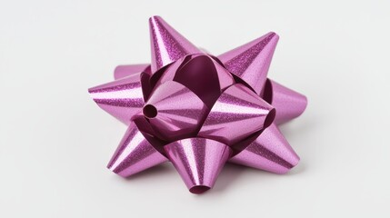  a pink bow on a white background The bow is made of a metallic material and has a glossy finish It is tied in a neat knot and is the focal point of the image The
