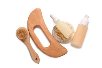 Beautiful composition with wooden guasha body massage tool and bottles of cosmetic product on white background