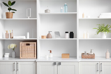 white shelving unit with bath supplies and cosmetic products in bathroom