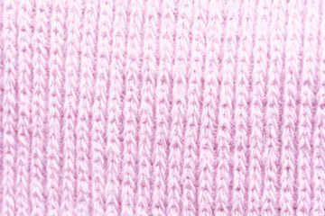 Soft pink knitted fabric showcasing intricate stitching patterns, perfect for cozy garments and home decor projects during winter crafting sessions