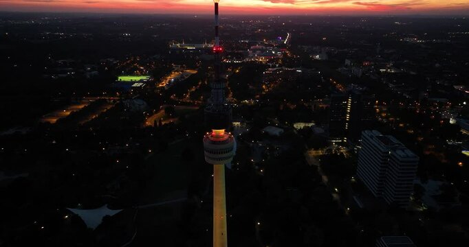 Aerial drone video of the tv tower of Dortmund, Germany, at sunset. City skyline view.