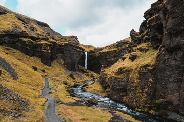 Icelandic waterfall Kvernufoss with beautiful cave and surrounding landscape 