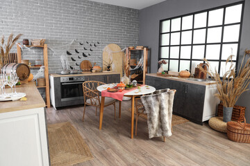 Interior of kitchen decorated for Halloween with counters and dining table
