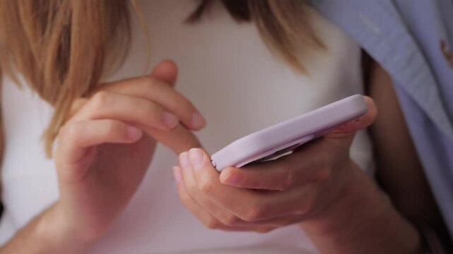CloseUp of a Person Using Smartphone with Stylish Case and browsing the internet
