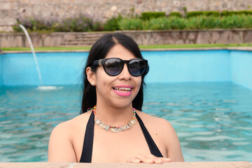 Hispanic woman in a pool in a Mexican setting