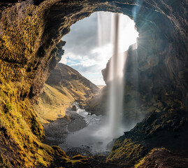 Icelandic waterfall Kvernufoss with beautiful cave and surrounding landscape 