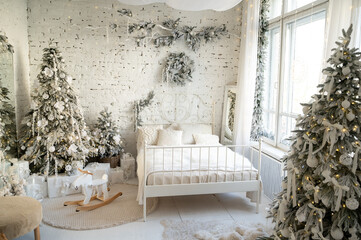 Bedroom interior decorated in a Christmas style. Christmas tree deer swing and bed.