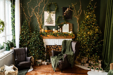 Fireplace room with Christmas decor. Classic armchairs, Christmas tree and fireplace