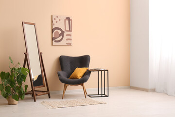 Armchair, coffee table and mirror in interior of living room