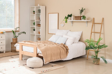Interior of cozy bedroom with shelf unit, ladder and plants