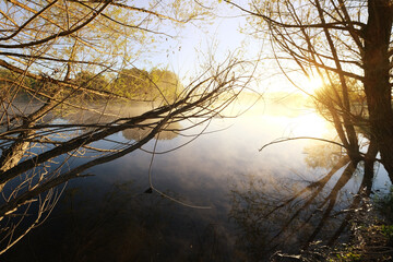 Sunrise over large pond in Texas landscape on chilly fall morning outdoors in nature.