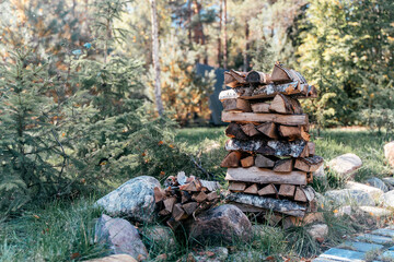 Firewood stacked outdoors. Camp firewood on nature