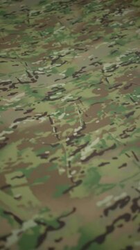Roll of camouflage fabric. Concept of tailoring clothes for military.