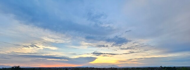 Red and yellow sunset over a green valley