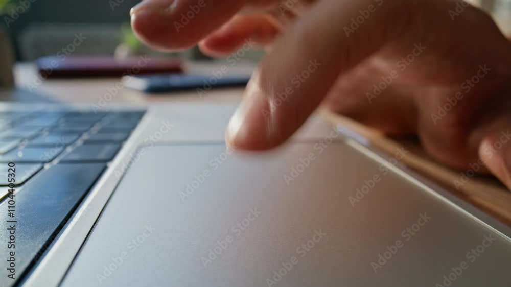 Wall mural closeup hand using touchpad laptop in workspace. macro shot unknown businessman