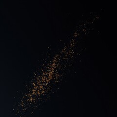 Golden glitter flakes on a dark black paper background, festive, luxury, sparkly