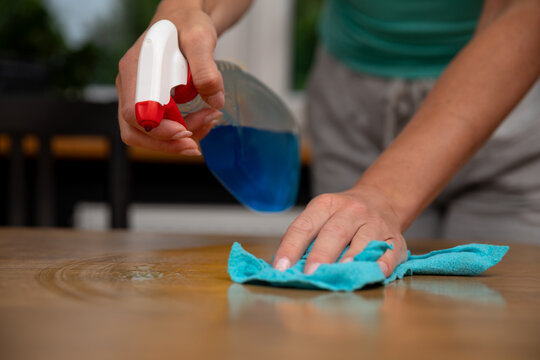 The process of cleaning a wooden surface using a spray and a cloth is quite effective