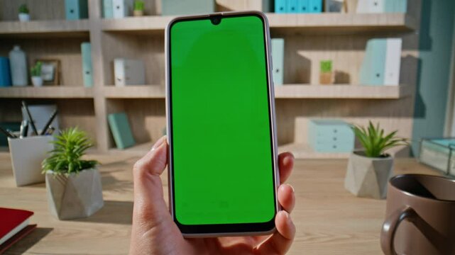 Lady finger swiping mockup smartphone watching social media at workplace closeup