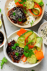 Rice bowl with teriyaki fish fillet and fresh crispy vegetables.top veiw