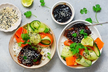 Rice bowl with teriyaki fish fillet and fresh crispy vegetables.top veiw