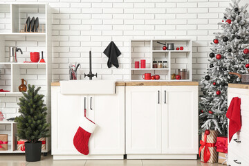 Interior of kitchen with Christmas trees, shelf units and counters