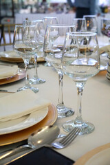 Table with glasses prepared for a formal dinner at a wedding