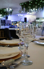 Glasses on a table prepared for a formal dinner at a wedding