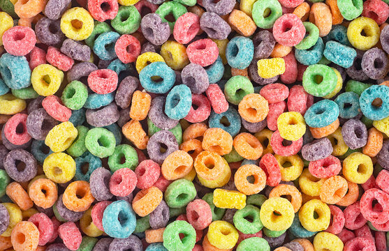 Background of round colorful cereals, top view. Colorful breakfast food. Colorful cereal rings.