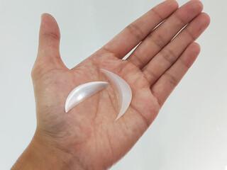 Silicone chin implants surgery, Doctor holding with hands, white background, medical equipment in...
