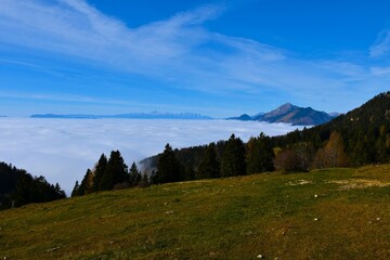 View of Gorenjska, Slovenia covered in low clouds with Julian alps and mountains Srednji vrh and Storzic from Krvavec