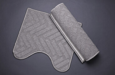 Bathroom and toilet gray rugs on dark gray background