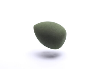 Floating Egg makeup sponge. Blender for foundation on white background. Minimal beauty concept