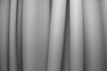 Fabric draping creates soft folds in monochrome tones in a serene setting