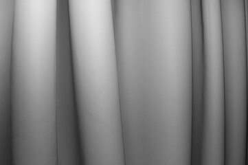 Fabric draping creates soft folds in monochrome tones in a serene setting