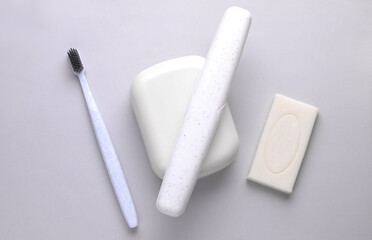 Soap dish and toothbrush storage case on grey background