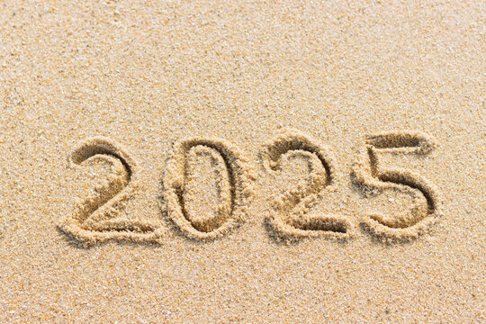 New Year 2025 concept. Numbers written on sand